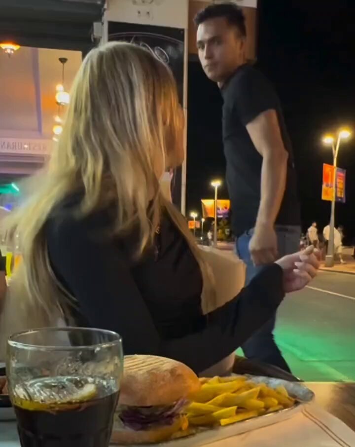 Blonde woman burger fries night scene