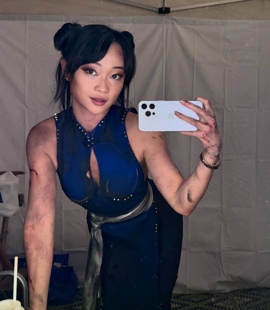 woman in blue ripped costume selfie