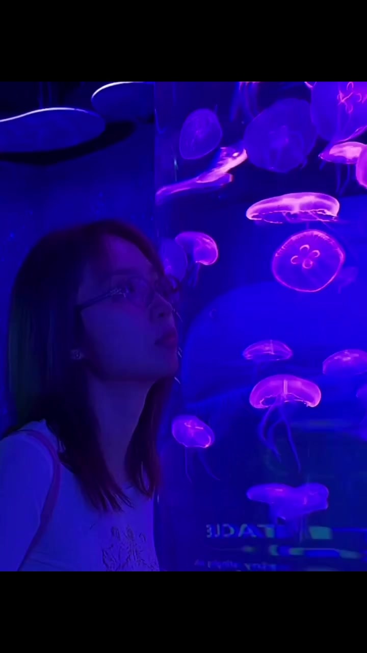 Woman looking at purple jellyfish