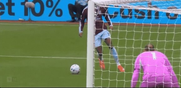 Soccer player kicking ball into goal
