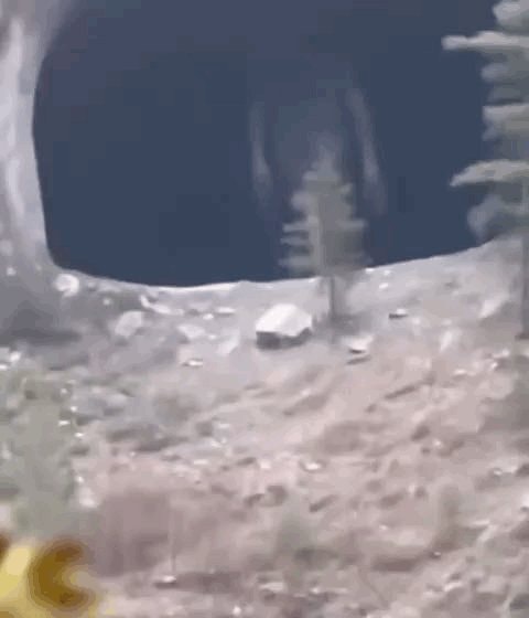 blurry figure in dark cave opening