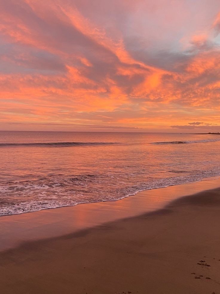 sunset beach scene with footprints