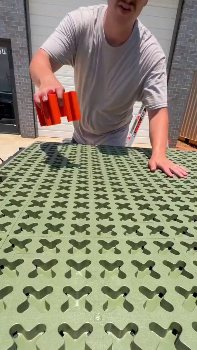 Orange object over green mats with LEVELER ladder