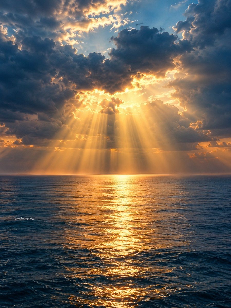 Sunbeams through clouds over ocean