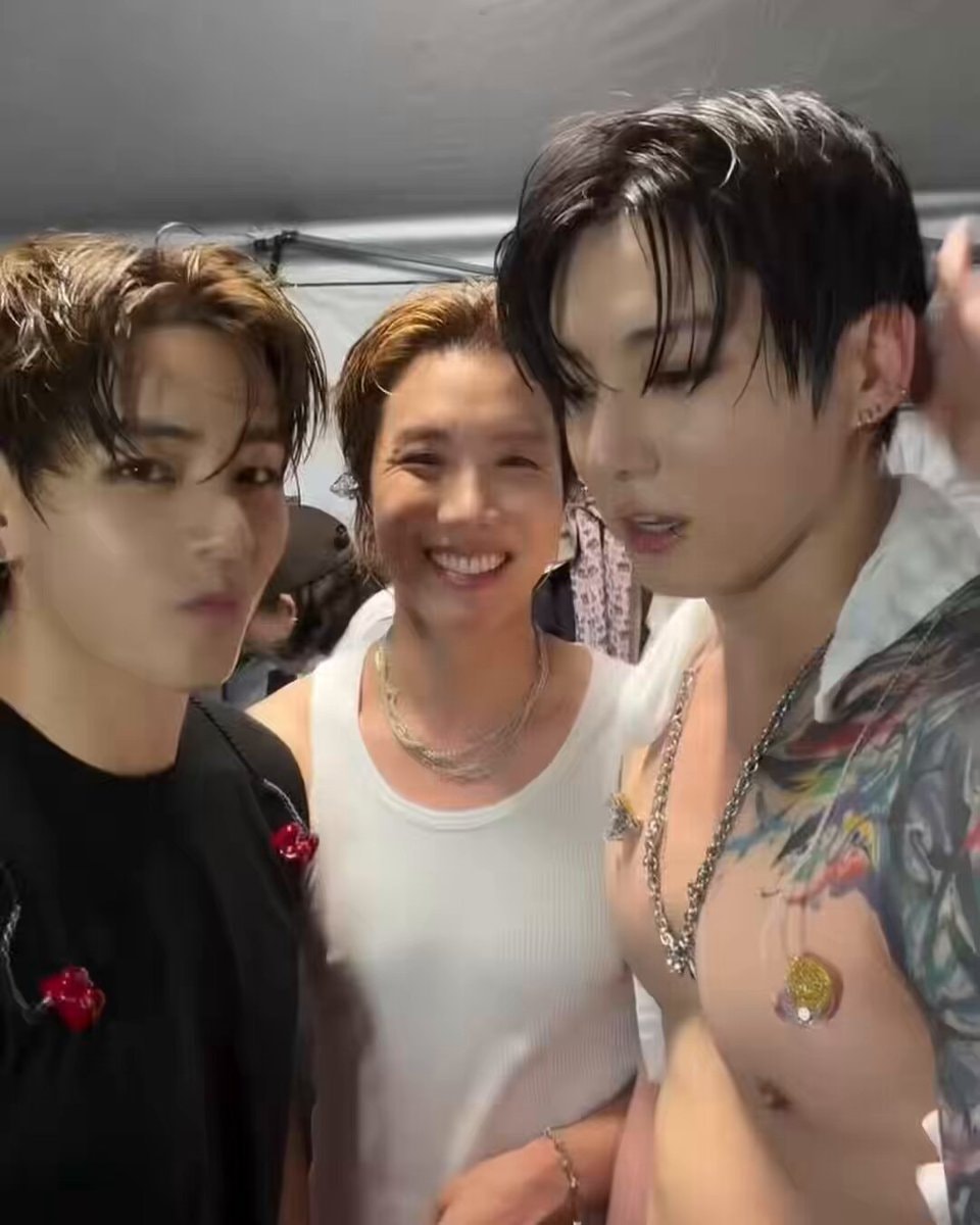 Three men backstage pose