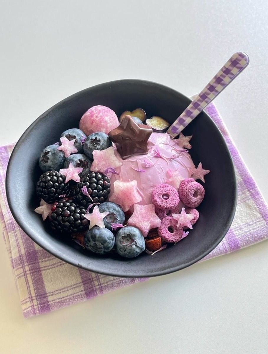 Pink ice cream bowl with berries and cereal
