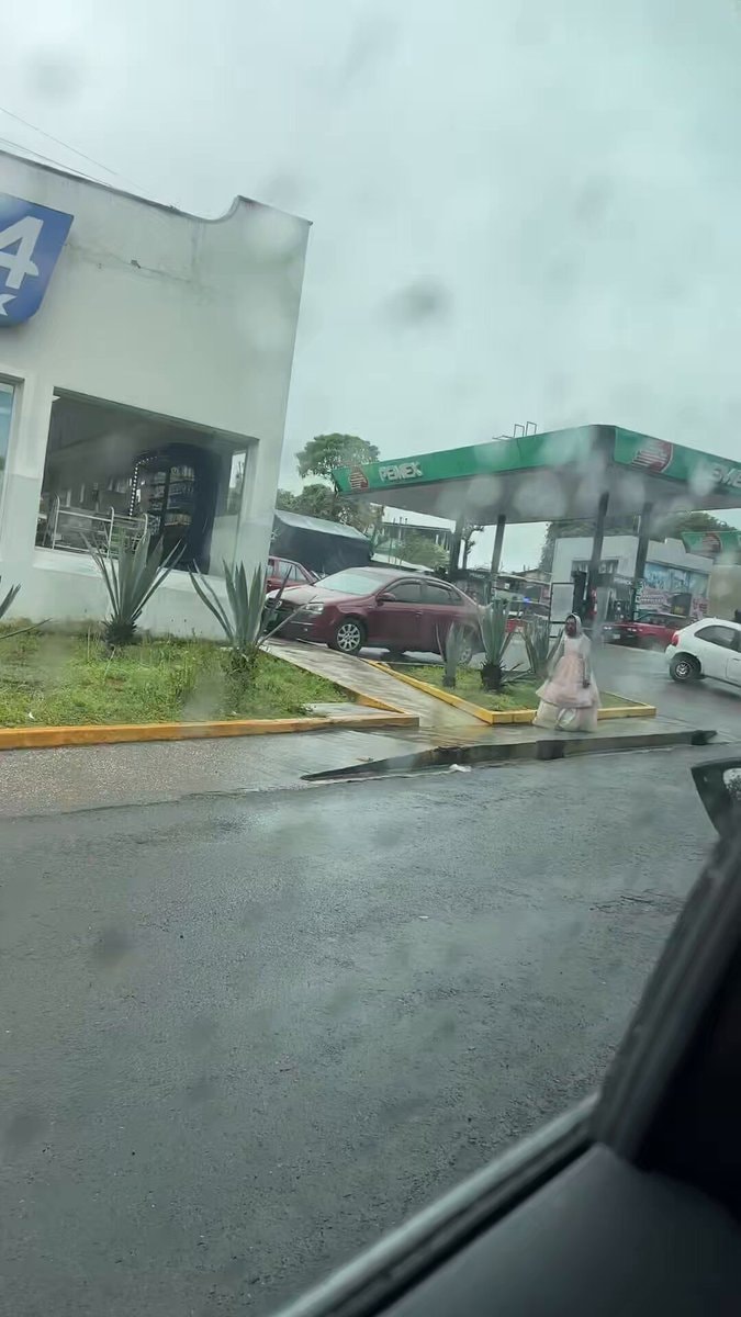 person in pink dress at gas station