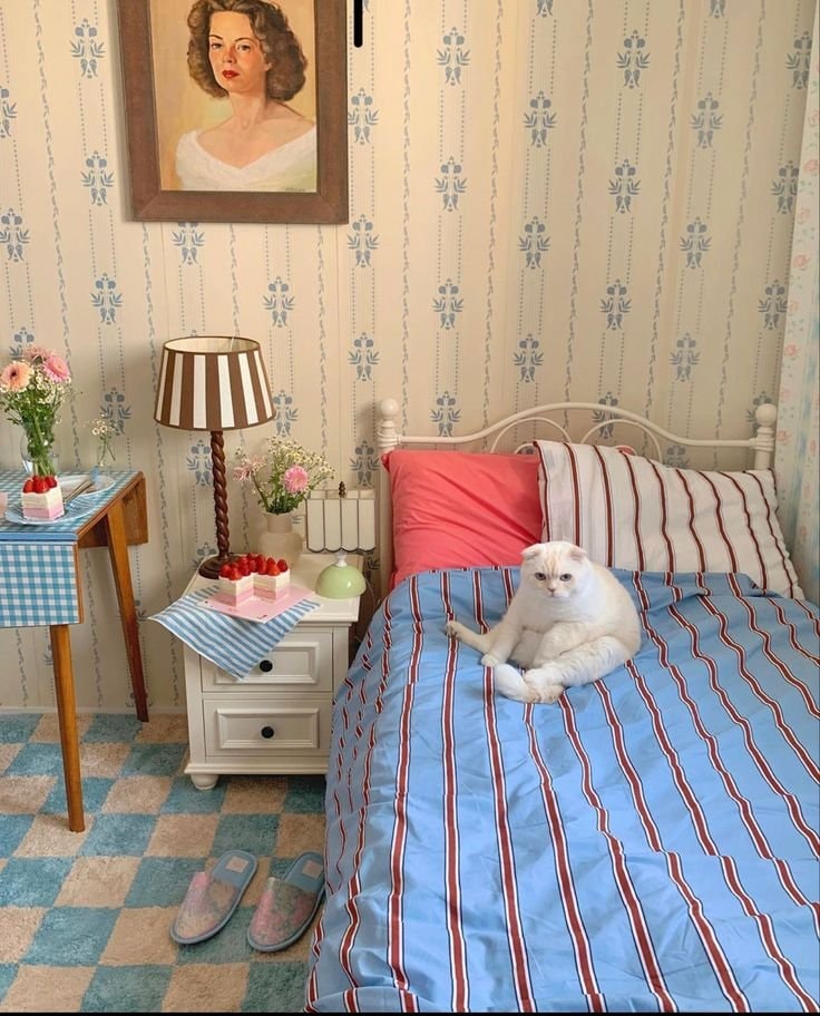 white cat on striped bedding