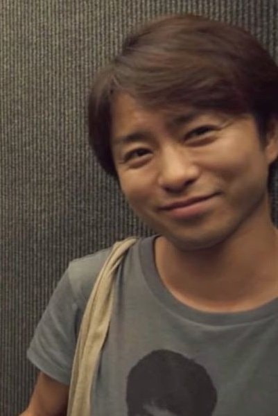 Man drinking from cup with Kazunari-san Shibuya text (photo 3 of 4)