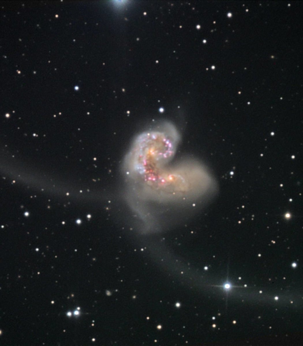 Two galaxies collide into a heart shape