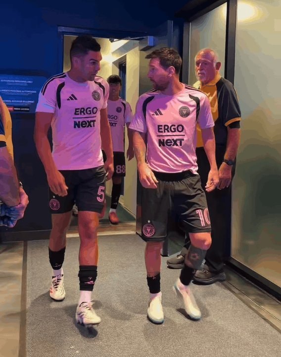 Messi and teammate walking