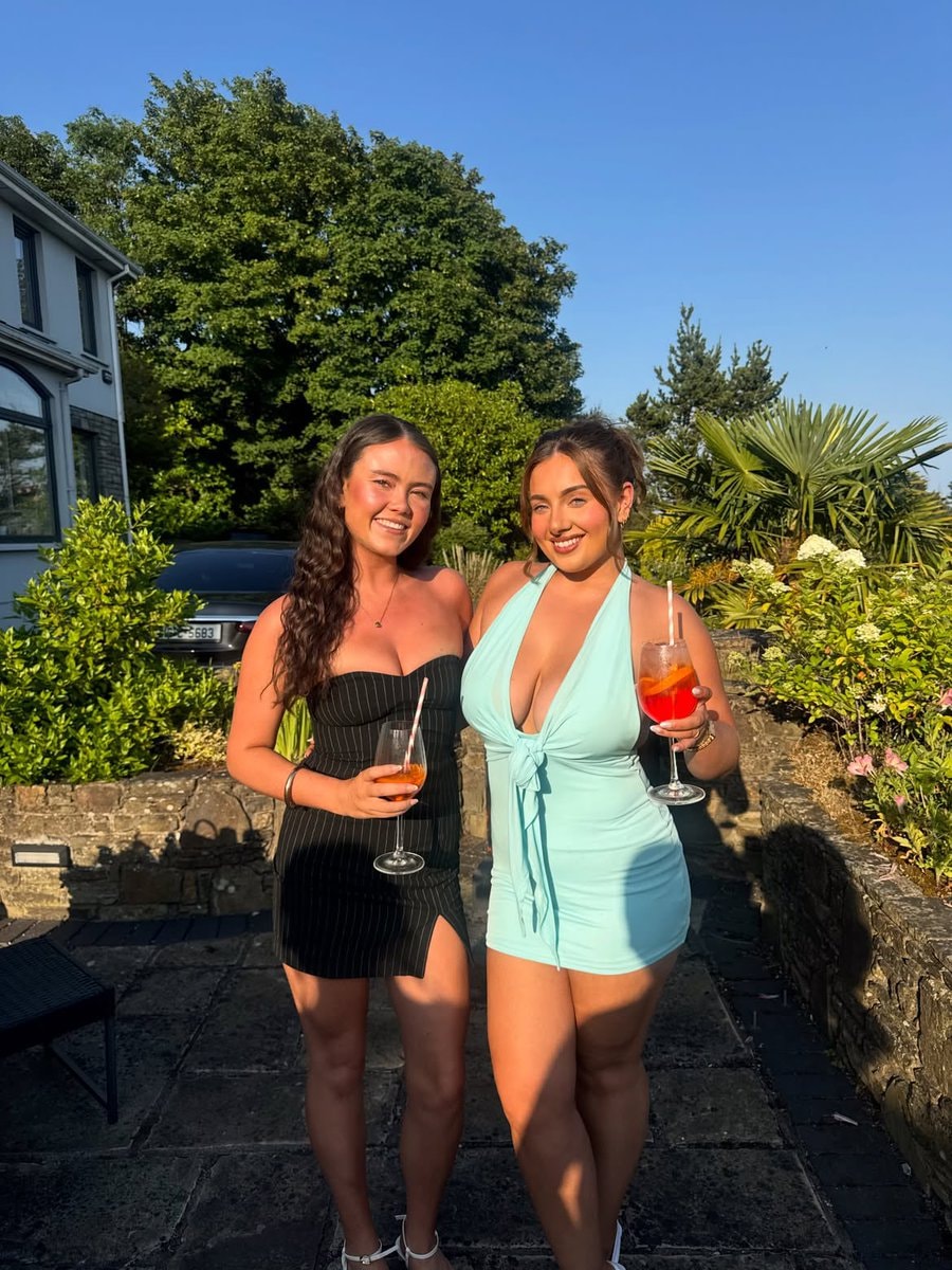 two women posing with drinks