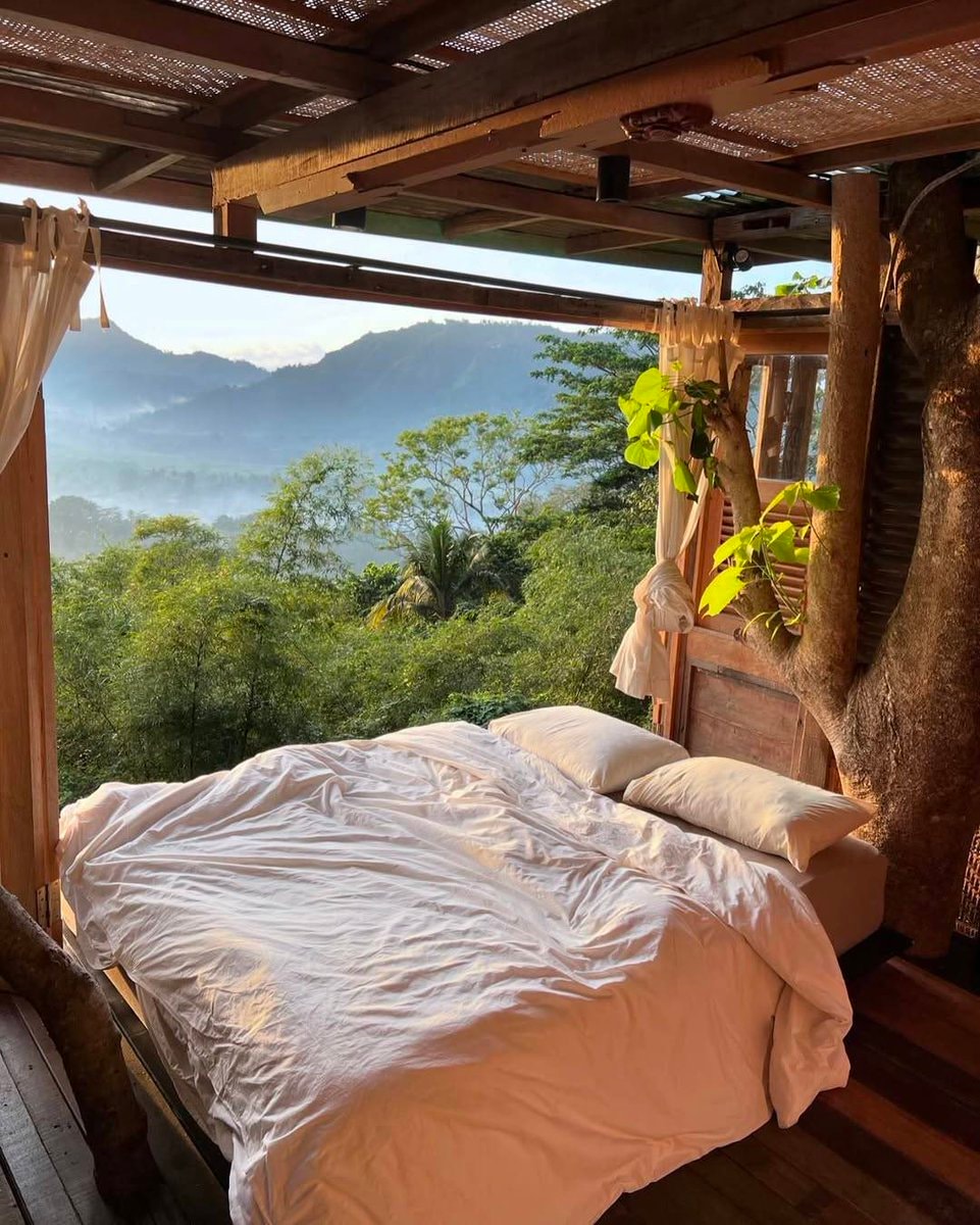 Bed in misty mountain landscape