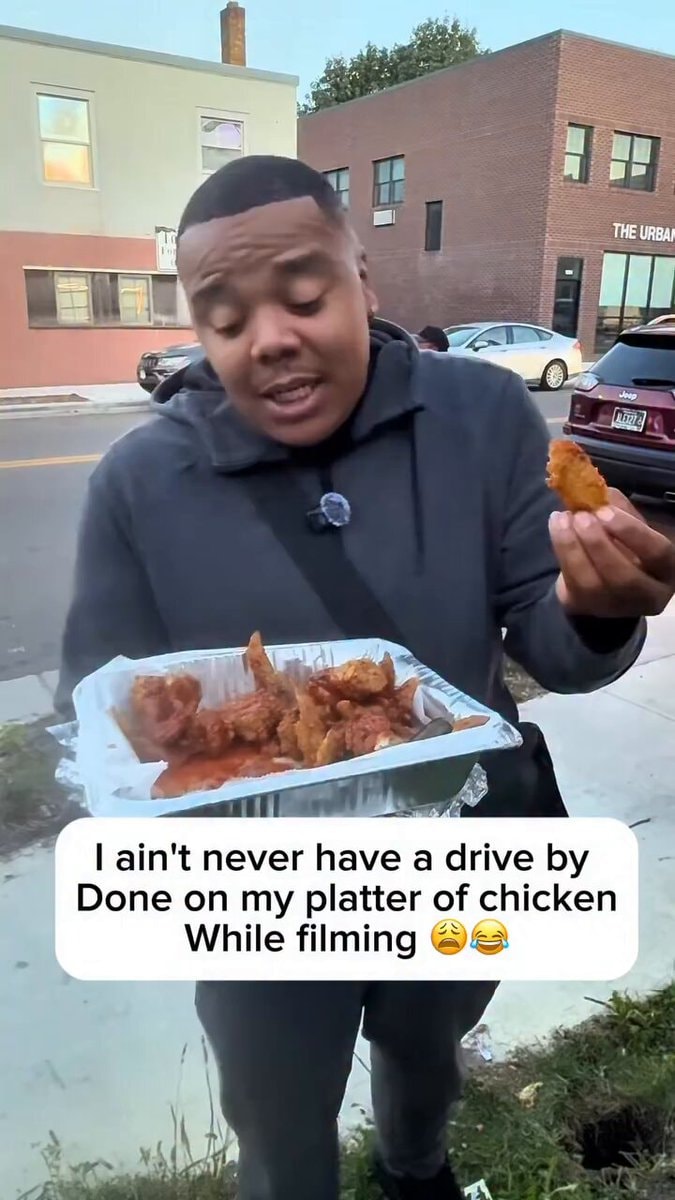 man takes chicken wing