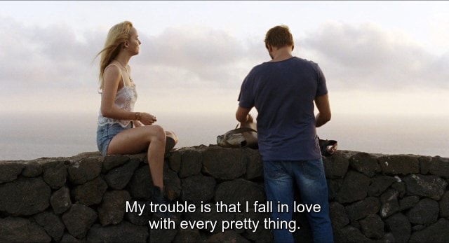 Text overlay on couple by the ocean