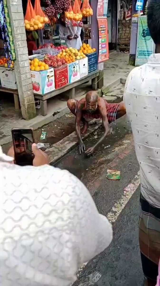 elderly man crouched on street