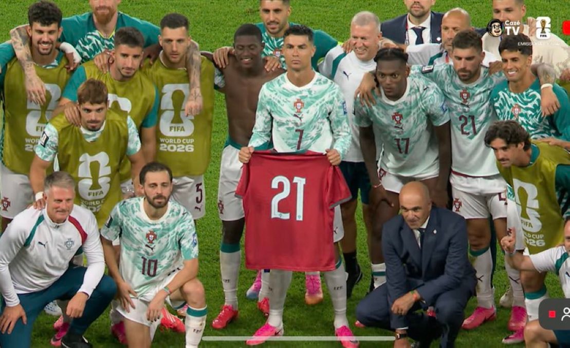 Portugal team with Ronaldo holding jersey 21