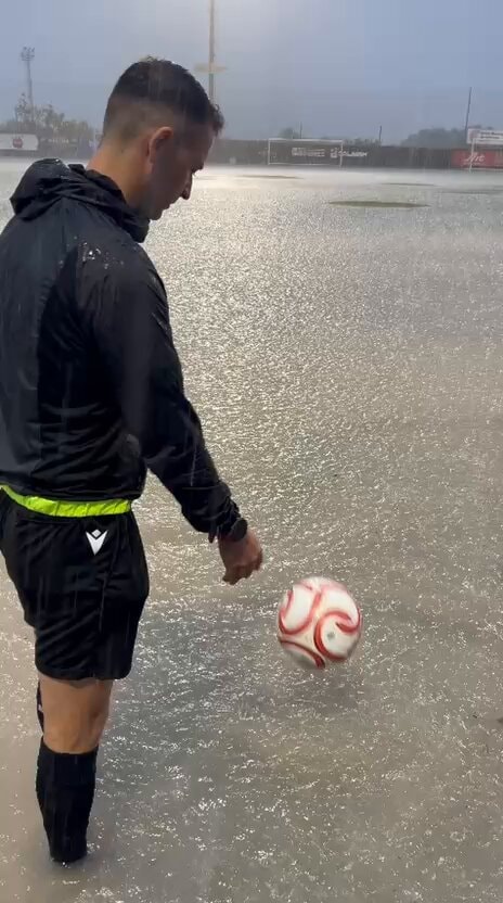 referee checks flooded pitch Spain fourth division referee checks flooded pitch Spain fourth division