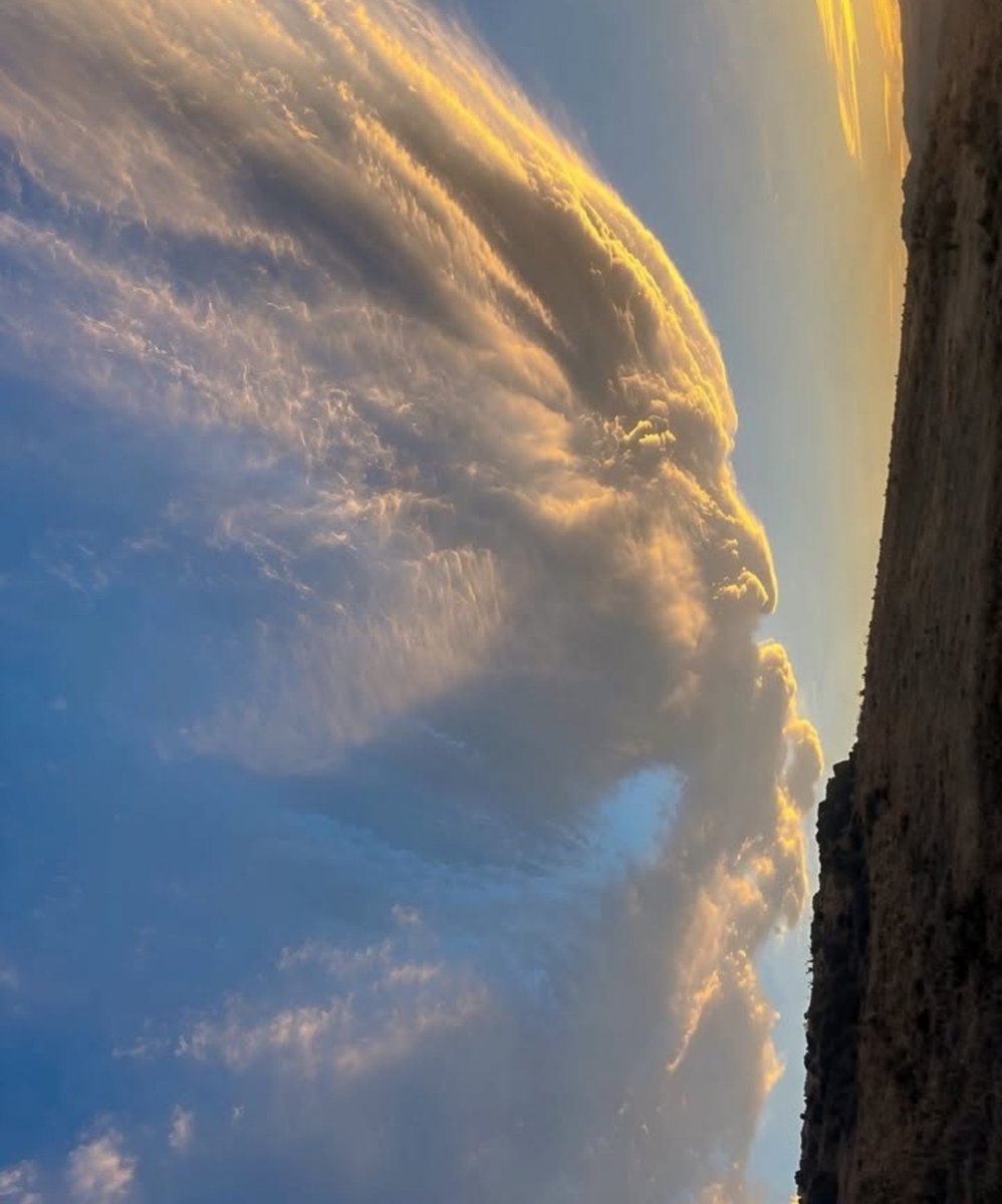 golden clouds over rocky cliff