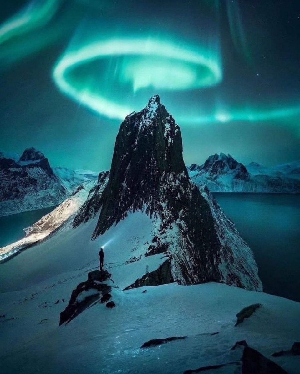 Aurora Borealis over snowy peak