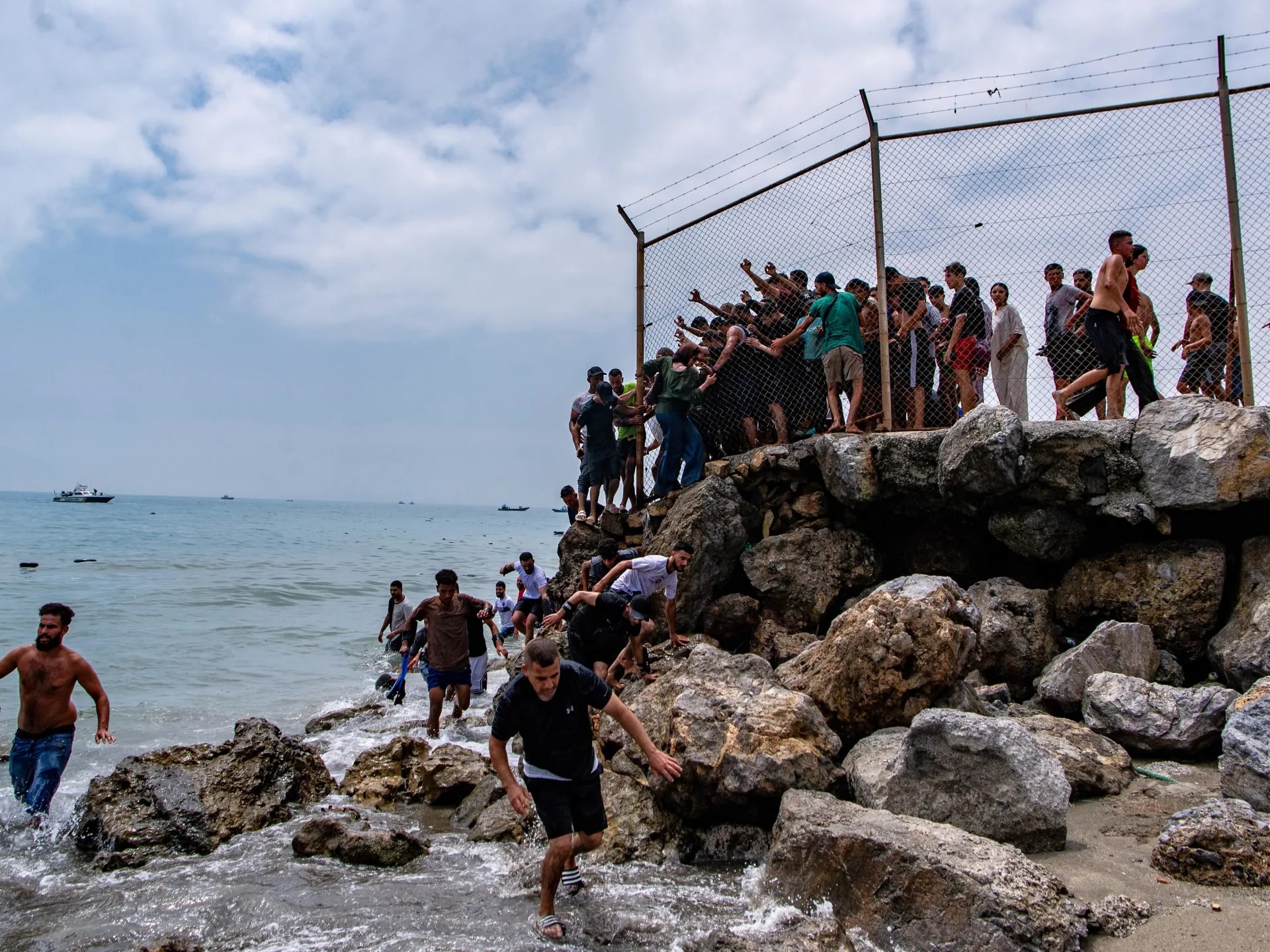 At least 18 die as thousands cross from Morocco into enclave of Ceuta